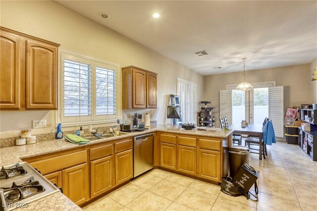 kitchen with light tile patterned floors, decorative light fixtures, a wealth of natural light, and dishwasher