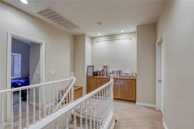 hallway with light colored carpet