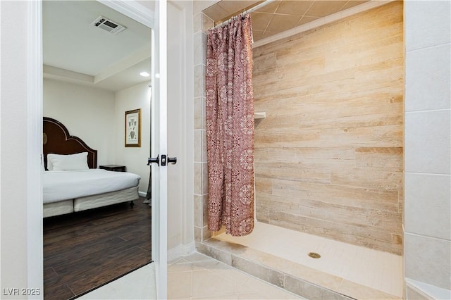 bathroom featuring tile patterned flooring and walk in shower