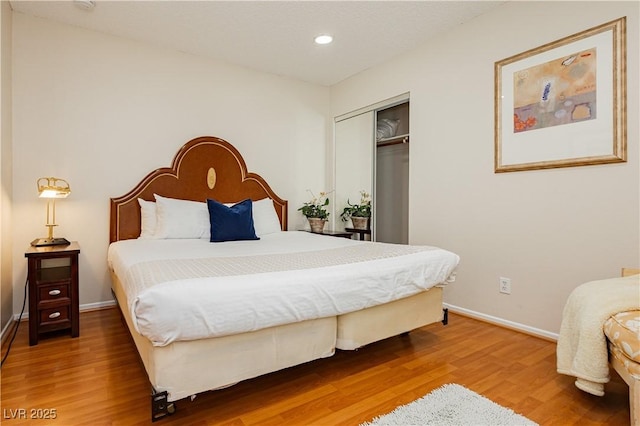 bedroom featuring hardwood / wood-style flooring and a closet