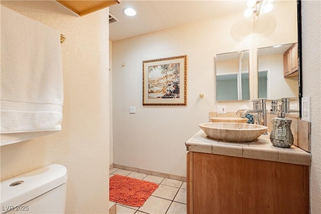 bathroom with vanity, tile patterned floors, and toilet