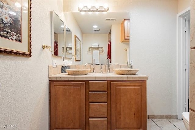 bathroom with vanity, tile patterned flooring, and toilet