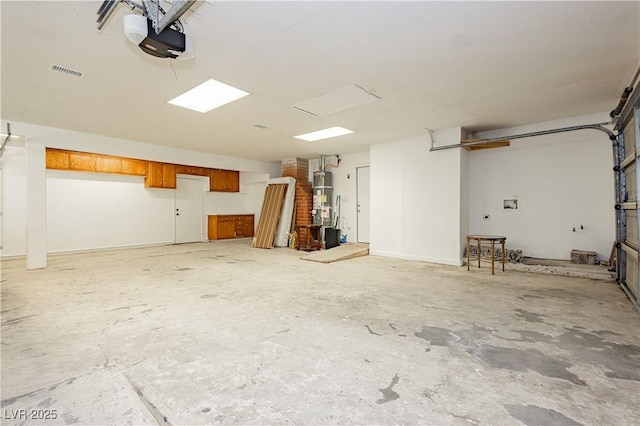 garage with a garage door opener and water heater