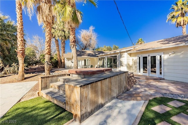 view of patio featuring french doors and a covered hot tub