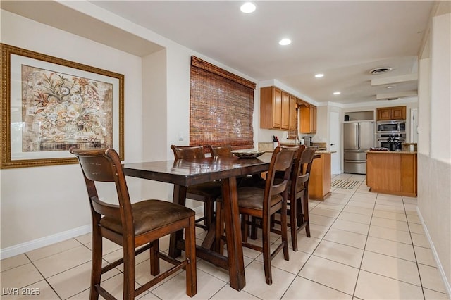 dining area with light tile patterned floors