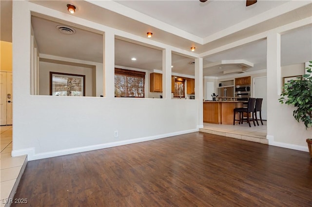 unfurnished living room featuring ceiling fan and light hardwood / wood-style floors