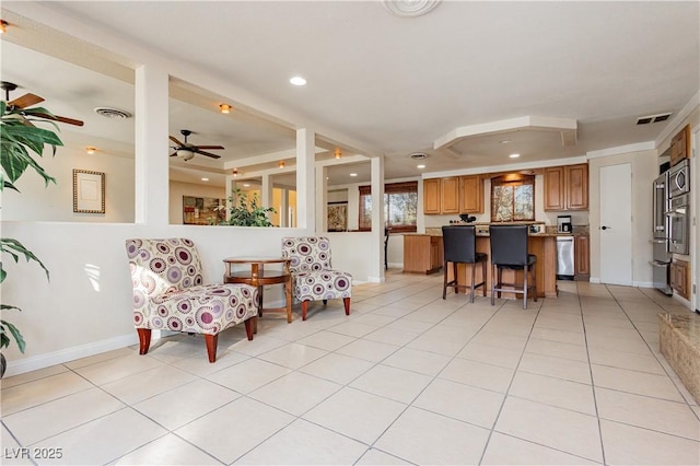 living room featuring light tile patterned floors and ceiling fan