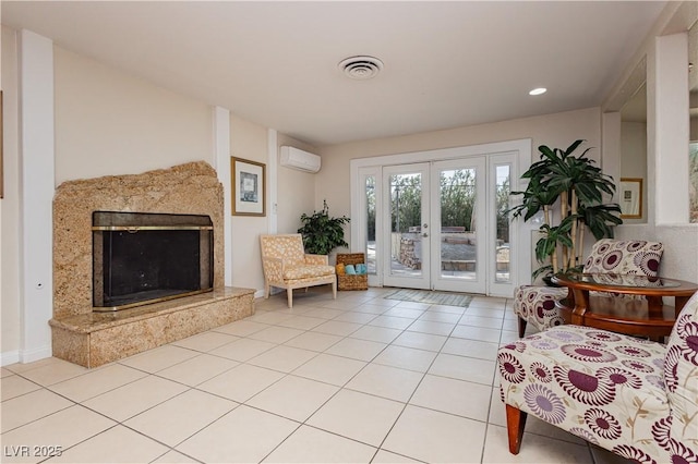 living area featuring french doors, a wall mounted AC, a high end fireplace, and light tile patterned floors