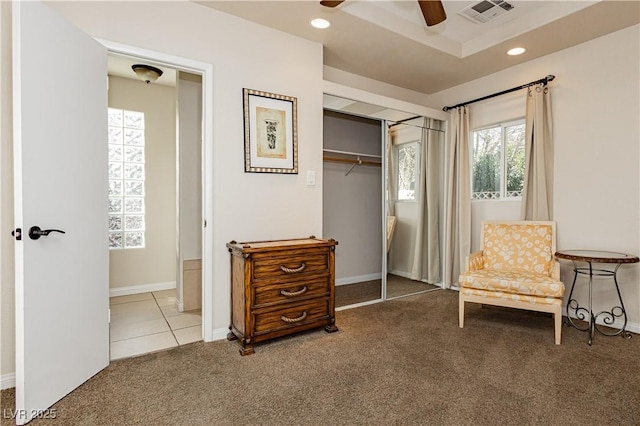 sitting room featuring ceiling fan, a tray ceiling, and carpet floors