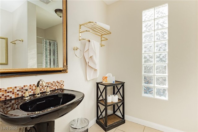 bathroom with backsplash, a shower with curtain, tile patterned floors, and sink