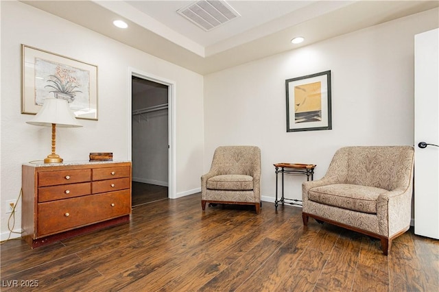 sitting room with dark wood-type flooring