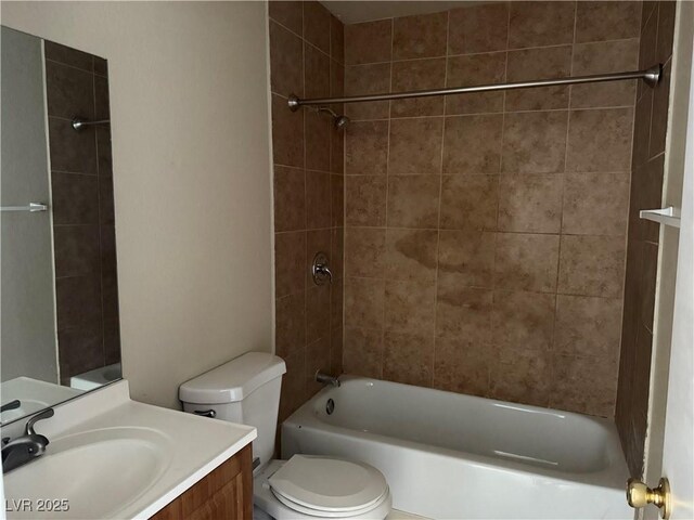 full bathroom with vanity, tiled shower / bath, and toilet