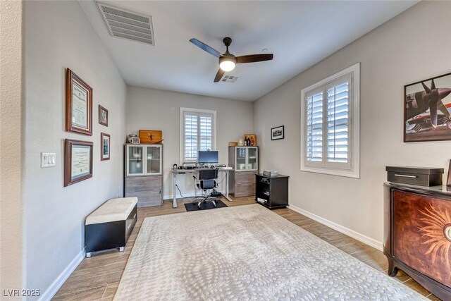 home office with hardwood / wood-style floors and ceiling fan