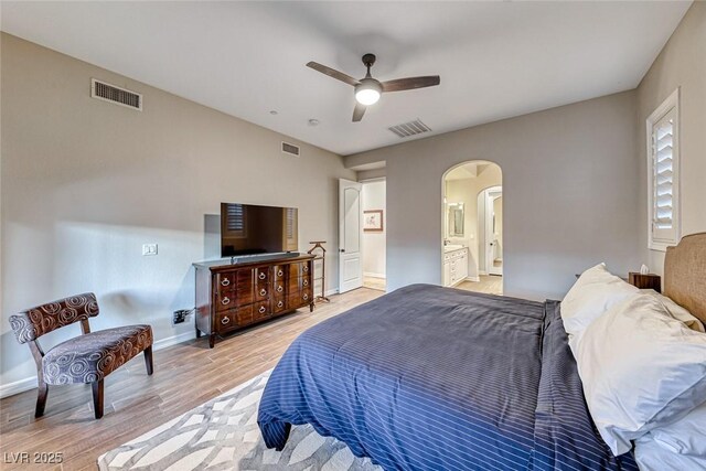 bedroom featuring ensuite bath, ceiling fan, and light hardwood / wood-style flooring