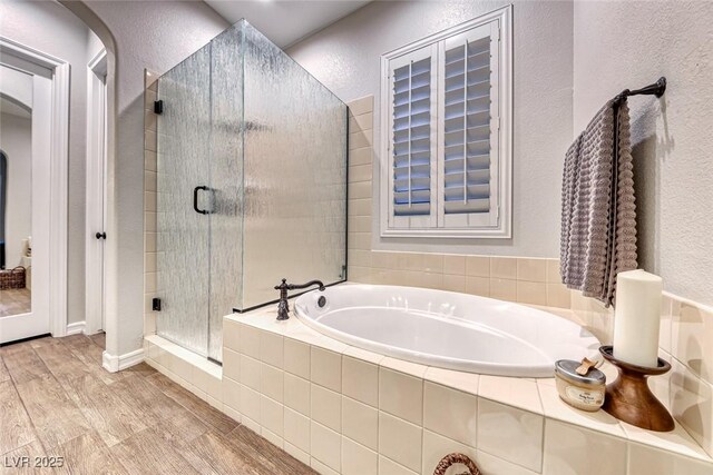 bathroom featuring shower with separate bathtub and hardwood / wood-style floors