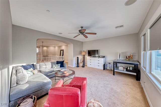 living room featuring ceiling fan and carpet