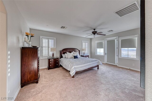 carpeted bedroom with ceiling fan and multiple windows