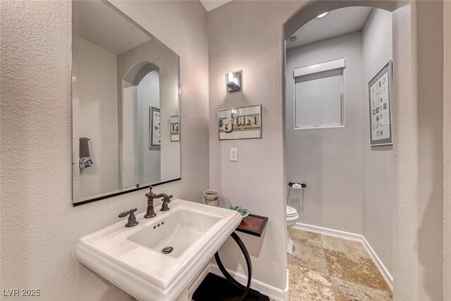 bathroom featuring sink and toilet