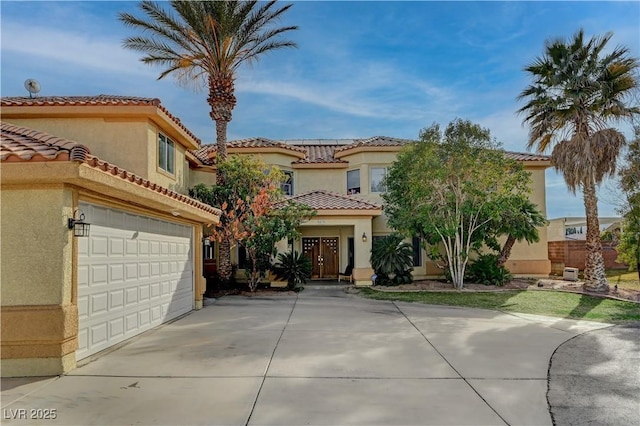 mediterranean / spanish home with a garage