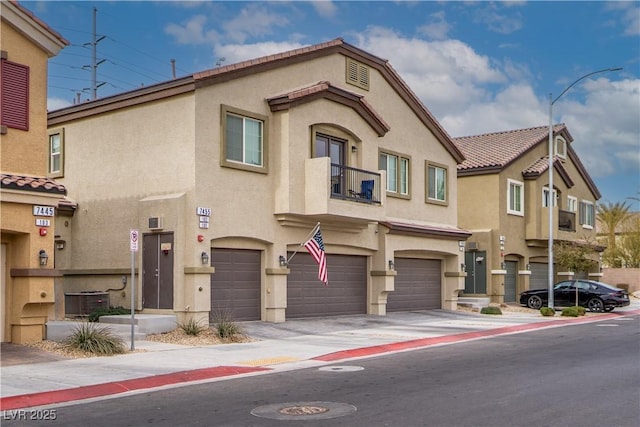 view of front of house with a garage and cooling unit