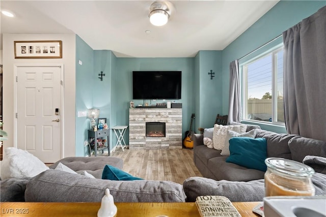 living room featuring wood-type flooring and a fireplace