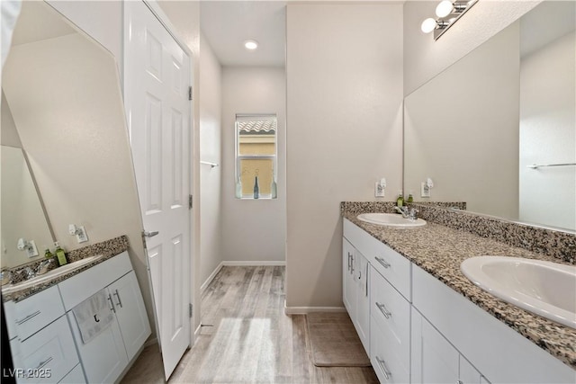 bathroom with hardwood / wood-style flooring and vanity