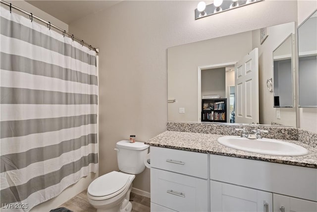 bathroom featuring vanity and toilet