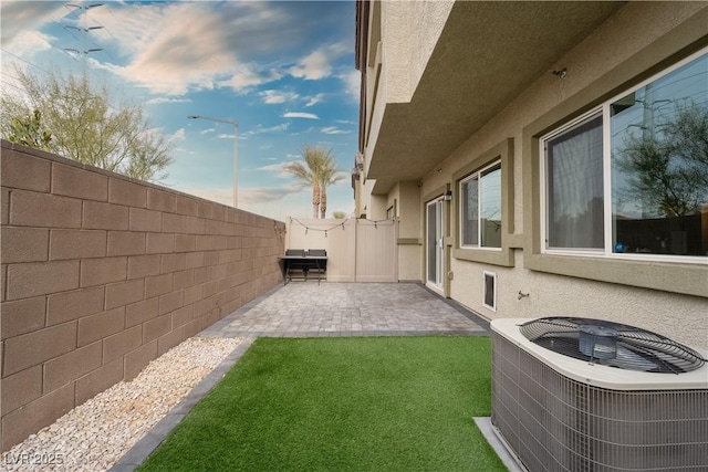 view of yard featuring cooling unit and a patio area