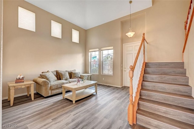 living room featuring hardwood / wood-style flooring and a high ceiling