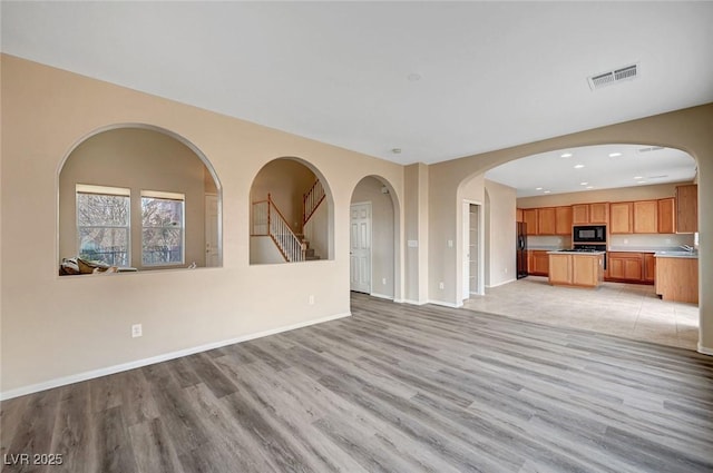 unfurnished living room featuring light wood-type flooring