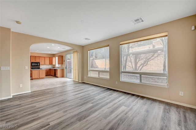 unfurnished living room with light wood-type flooring