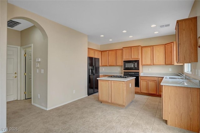 kitchen with a kitchen island, sink, and black appliances