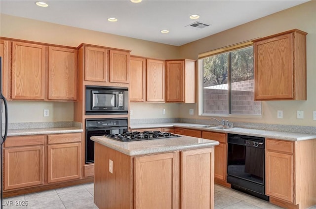 kitchen with a kitchen island, sink, light tile patterned floors, and black appliances