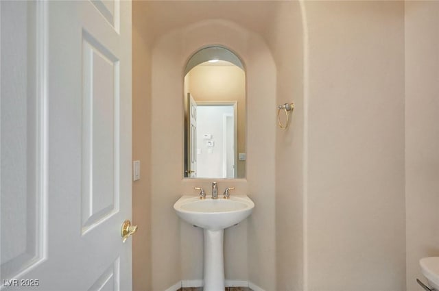 bathroom featuring sink and toilet