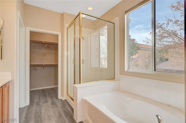 bathroom featuring vanity, wood-type flooring, and independent shower and bath