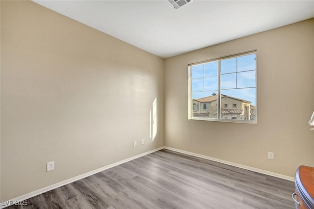 unfurnished room featuring wood-type flooring