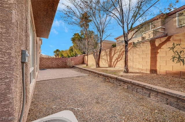 view of yard with cooling unit and a patio area