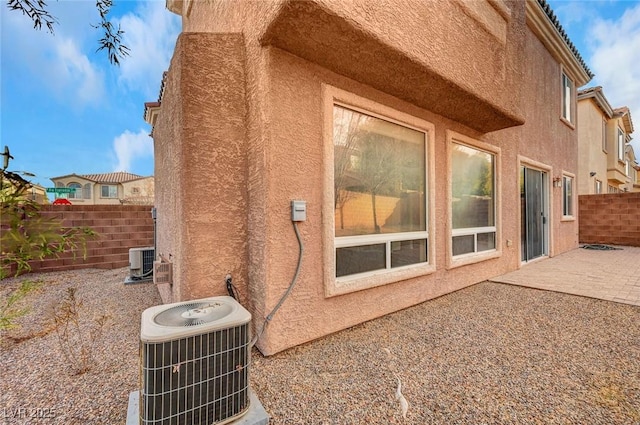 view of property exterior featuring central AC and a patio area