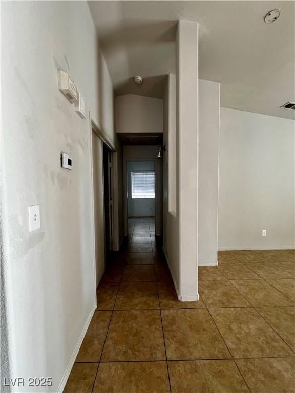 corridor with dark tile patterned floors