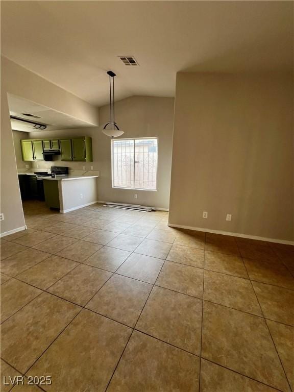 interior space with lofted ceiling and light tile patterned floors