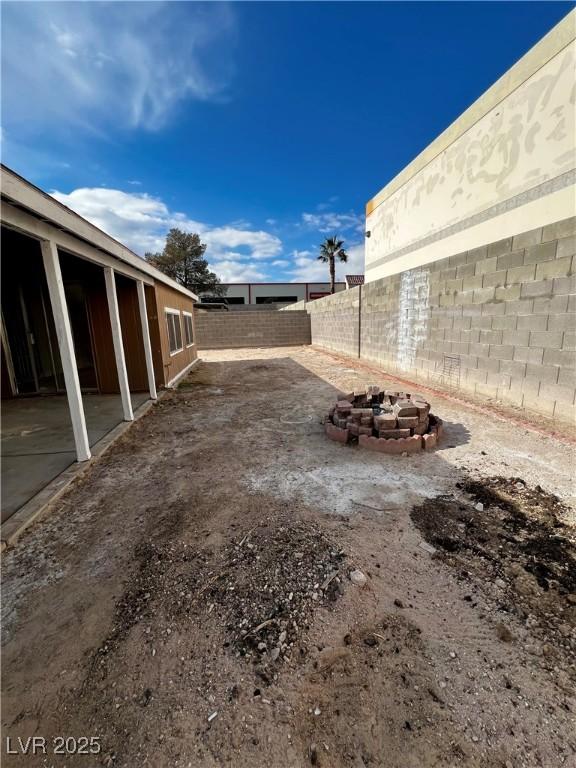 view of yard with an outdoor fire pit