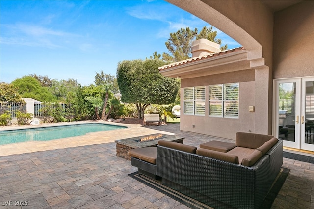 view of pool with a patio and a fire pit