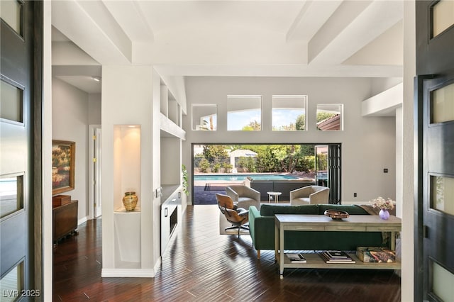 living room with wood-type flooring and a high ceiling