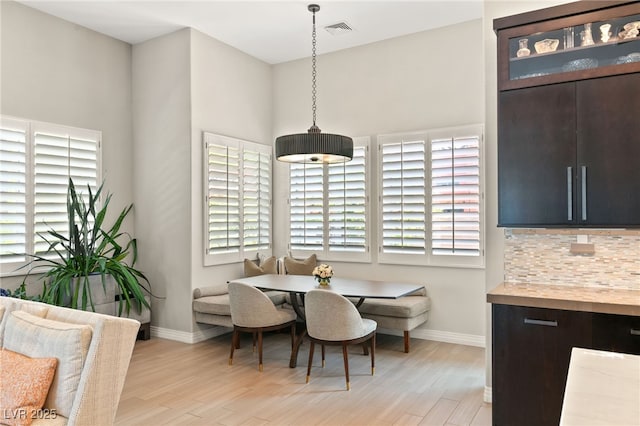 dining space featuring breakfast area, light hardwood / wood-style flooring, and a healthy amount of sunlight