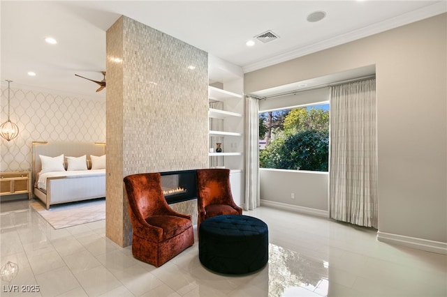 sitting room featuring crown molding and ceiling fan