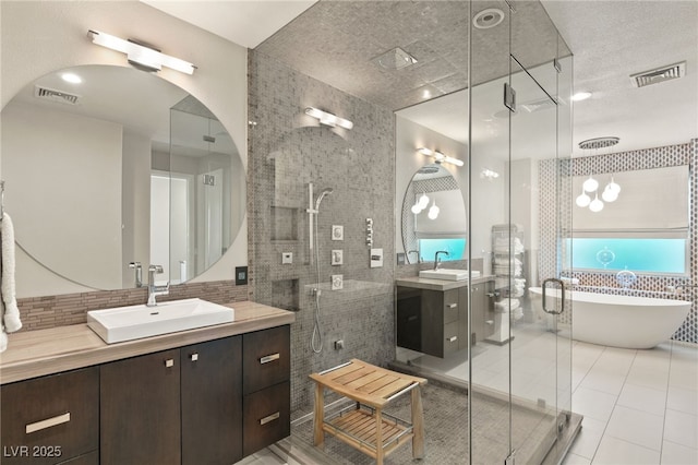 bathroom featuring a healthy amount of sunlight, shower with separate bathtub, tile walls, and vanity