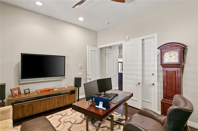 office with hardwood / wood-style flooring and ceiling fan