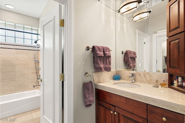 bathroom with tile patterned floors, vanity, and tiled shower / bath combo