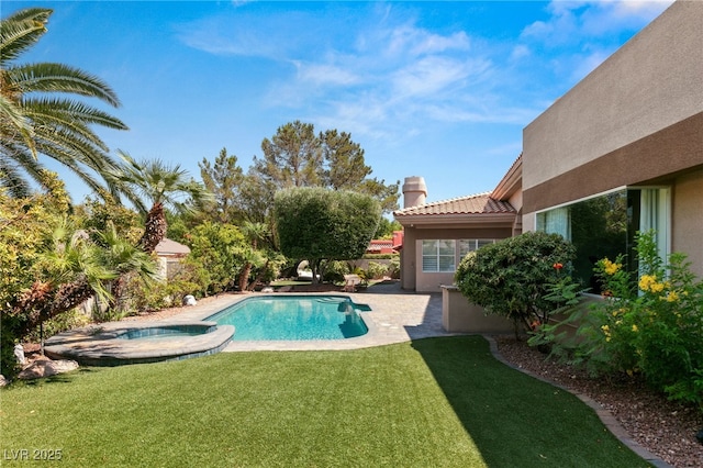 view of pool with an in ground hot tub, a patio, and a lawn