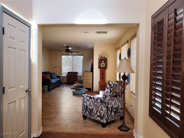 interior space with ceiling fan and visible vents